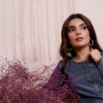 Stylish woman in embroidered dress with flowers, exuding elegance and traditional charm.